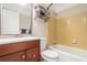 Traditional bathroom featuring a wood vanity, framed mirror, and tub with yellow tiling surround at 3262 Bluff Rd, Marietta, GA 30062