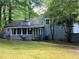Exterior of home with patio and sunroom surrounded by trees at 3262 Bluff Rd, Marietta, GA 30062