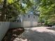 Home exterior showing a multi-car garage and long drive with mature trees around property at 3262 Bluff Rd, Marietta, GA 30062