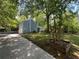 Charming two-story home featuring a long driveway and mature trees providing shade at 3262 Bluff Rd, Marietta, GA 30062