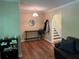 Foyer with hardwood floors, complemented by a console table and a view of the staircase at 3262 Bluff Rd, Marietta, GA 30062