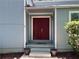 Inviting front entrance with a double door and a step, framed by potted plants at 3262 Bluff Rd, Marietta, GA 30062
