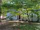 Landscaped front yard with a mature tree, complementing the blue exterior of the home at 3262 Bluff Rd, Marietta, GA 30062