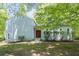 Inviting front facade with vibrant green lawn and mature shade trees at 3262 Bluff Rd, Marietta, GA 30062