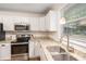 Bright kitchen featuring updated appliances, granite countertops, and ample storage at 3262 Bluff Rd, Marietta, GA 30062