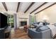 Bright living room with a stone fireplace, wood floors, and sliding doors to the outside at 3262 Bluff Rd, Marietta, GA 30062