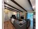 Cozy living room with exposed beams, a stone fireplace, and a comfortable gray sofa at 3262 Bluff Rd, Marietta, GA 30062