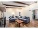 Cozy living room with exposed beams, fireplace, wood floors, and a comfortable sectional sofa at 3262 Bluff Rd, Marietta, GA 30062