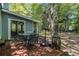 Outdoor patio with a dining set, grill, mature trees, and privacy at 3262 Bluff Rd, Marietta, GA 30062