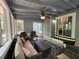 Comfortable sunroom features wicker furniture and neutral paint with a striking black and white rug at 3262 Bluff Rd, Marietta, GA 30062