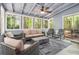 Charming sunroom with blue walls, a ceiling fan, and comfortable seating with wooded views at 3262 Bluff Rd, Marietta, GA 30062
