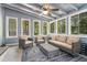Serene sunroom featuring an area rug, multiple windows, a ceiling fan, and cozy furniture at 3262 Bluff Rd, Marietta, GA 30062