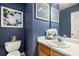 Powder room featuring a vanity with solid surface countertop, a toilet, and framed art at 360 Parkview Manor Dr, Tucker, GA 30084