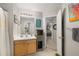Well-lit bathroom featuring a vanity with storage, large mirror, shower curtain, and access to the hallway and bedroom at 360 Parkview Manor Dr, Tucker, GA 30084