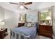 Bedroom with natural light features a full-sized bed with decorative pillows, dark wood furniture, and neutral wall color at 360 Parkview Manor Dr, Tucker, GA 30084