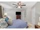 Bedroom features a bed with patterned pillows and blanket, dresser with a TV, and white walls at 360 Parkview Manor Dr, Tucker, GA 30084