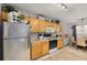 Galley style kitchen with light wood cabinets and stainless steel refrigerator at 360 Parkview Manor Dr, Tucker, GA 30084