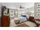 Spacious main bedroom with a ceiling fan, neutral walls, and decorative wall art at 360 Parkview Manor Dr, Tucker, GA 30084