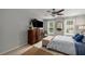 Bedroom features a comfortable bed, a spacious dresser with a TV, and natural light from the windows at 360 Parkview Manor Dr, Tucker, GA 30084