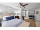 Bright main bedroom with a ceiling fan, decorative art, and walk-in closet access at 360 Parkview Manor Dr, Tucker, GA 30084
