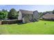Expansive backyard featuring a lush lawn, patio seating, shed, and privacy fence at 4765 Smokestone Dr, Douglasville, GA 30135