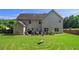 Backyard features a circular pattern in the grass, a gray house, and a stone bench for outdoor enjoyment at 4765 Smokestone Dr, Douglasville, GA 30135