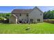 Large backyard with a unique grass design and patio area for outdoor entertainment at 4765 Smokestone Dr, Douglasville, GA 30135