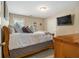 Comfortable bedroom with a wood bed frame and a TV on the wall at 4765 Smokestone Dr, Douglasville, GA 30135