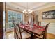 Elegant dining room with a dark wood table, chandelier, and large window offering lots of natural light at 4765 Smokestone Dr, Douglasville, GA 30135