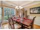 Formal dining room showcasing a table set for a meal, complemented by natural light from a large window at 4765 Smokestone Dr, Douglasville, GA 30135
