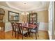 Elegant dining room features hardwood floors, wainscoting, a stylish chandelier and a display cabinet at 4765 Smokestone Dr, Douglasville, GA 30135