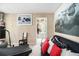 Bright exercise room includes a treadmill, punching bag, and futon, offering a versatile space for fitness and relaxation at 4765 Smokestone Dr, Douglasville, GA 30135