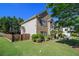 Charming two-story brick home with lush landscaping, mature trees, and a manicured lawn at 4765 Smokestone Dr, Douglasville, GA 30135