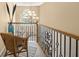 Hallway with decorative wrought iron railing, chandelier, and lots of natural light at 4765 Smokestone Dr, Douglasville, GA 30135