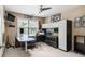 This well-lit home office features built-in shelving, a ceiling fan, and a large desk, perfect for productivity at 4765 Smokestone Dr, Douglasville, GA 30135