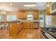 Inviting kitchen features stainless appliances, warm wood cabinetry, tile backsplash, and ample countertop space at 4765 Smokestone Dr, Douglasville, GA 30135