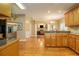Open concept kitchen with stainless steel appliances, wooden cabinets, hardwood floors and an open view at 4765 Smokestone Dr, Douglasville, GA 30135