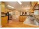 Spacious kitchen featuring stainless steel appliances, wooden cabinets, and an adjoining breakfast nook and living area at 4765 Smokestone Dr, Douglasville, GA 30135