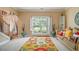 Sunlit living room showcasing vibrant rug and cozy sofa, perfect for relaxation or entertaining guests at 4765 Smokestone Dr, Douglasville, GA 30135