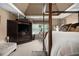 A bedroom with a four-poster bed, carpeted floors, an armoire with a TV, and neutral-colored walls at 4765 Smokestone Dr, Douglasville, GA 30135