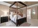 View of the main bedroom showcasing the four-poster bed with a decorative rug beneath at 4765 Smokestone Dr, Douglasville, GA 30135