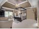 A spacious main bedroom with carpet floors, a tray ceiling, and a four-poster bed at 4765 Smokestone Dr, Douglasville, GA 30135