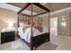 Primary bedroom with a four-poster bed, decorative rug and adjacent bathroom at 4765 Smokestone Dr, Douglasville, GA 30135