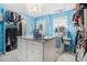 Gorgeous walk-in closet with island, chandelier, and custom shelving at 4765 Smokestone Dr, Douglasville, GA 30135