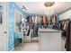 Bright walk-in closet with custom shelving, island, and vanity area at 4765 Smokestone Dr, Douglasville, GA 30135