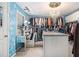 Designer walk-in closet with custom shelves, cabinets, makeup vanity, and a chandelier at 4765 Smokestone Dr, Douglasville, GA 30135