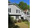Close up of two-story home with gray siding, black shutters, and a well-maintained front yard at 615 Amberwood Pl, Euharlee, GA 30145