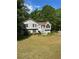 Charming two-story home with gray siding, black shutters, and a well-maintained front yard at 615 Amberwood Pl, Euharlee, GA 30145