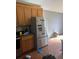 Stainless steel refrigerator and wood cabinets in a functional kitchen with tiled backsplash at 615 Amberwood Pl, Euharlee, GA 30145