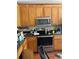 Close up of functional kitchen with wood cabinets and stainless steel appliances at 615 Amberwood Pl, Euharlee, GA 30145